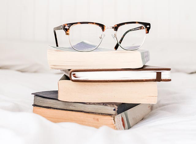 A Pair of Glasses on a Stack of Books