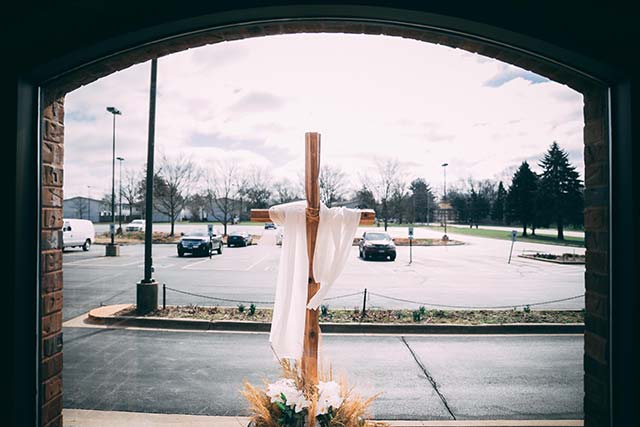 Cross in front of a parking lot