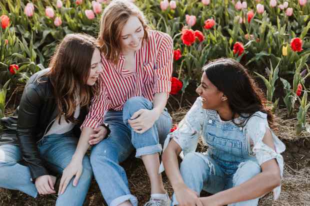 Three women talking and laughing