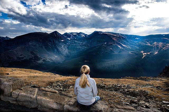 Woman looking over mountain range thinking about Elohim