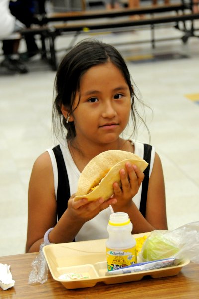 Small girl holding lunch