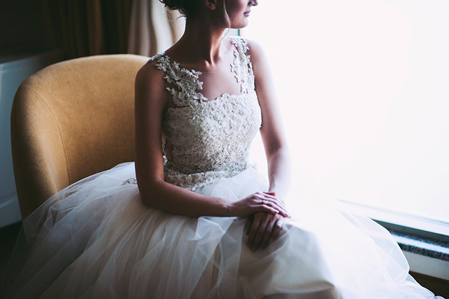 Bride sitting at window